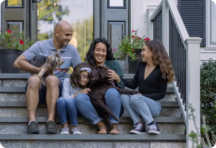 Family sitting on front porch.